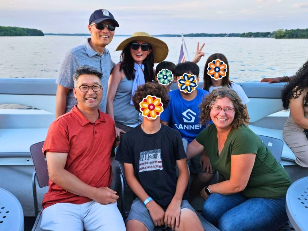 KKOOM Board members, volunteeers, and youth enjoying a boat outing during a summer event.