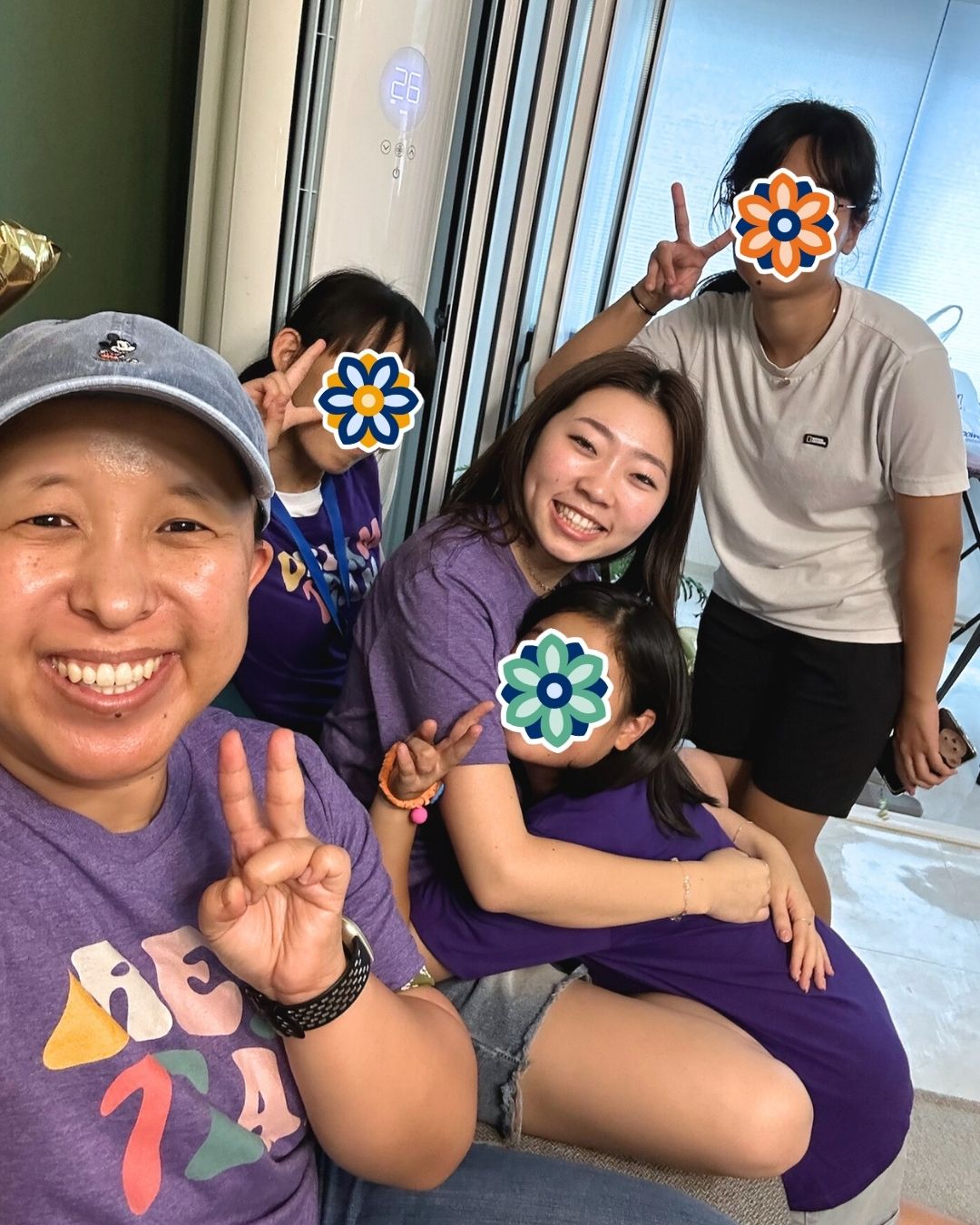 KKOOM staff and GEM Program students smiling and relaxing together after a group activity.