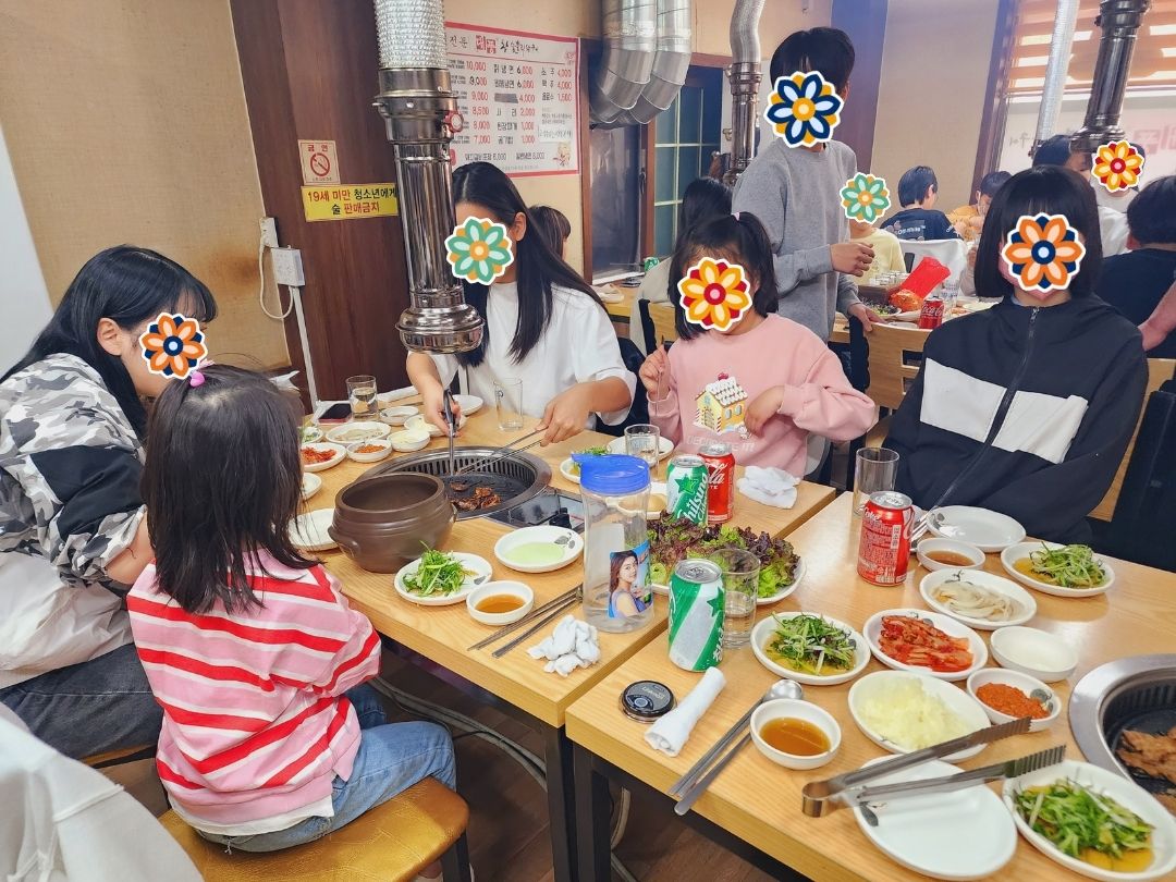 Children and volunteers sharing a meal during a holiday gathering.