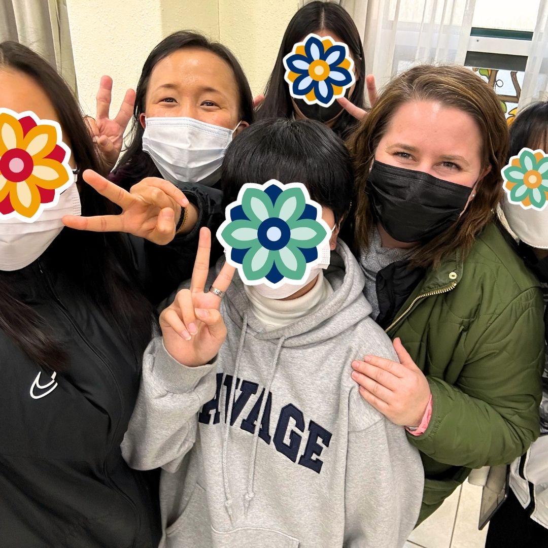 KKOOM staff and Board member posing for the camera with children during a KKOOM holiday party.