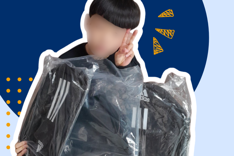 Student holding new school uniform and backpack provided through KKOOM’s back-to-school support program.