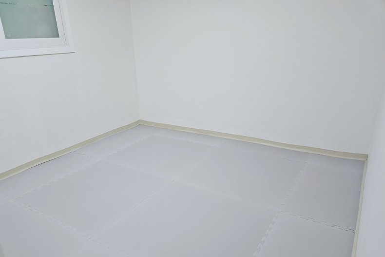 Empty room that will become a safe indoor playroom for infants and toddlers at a Korean children’s home.