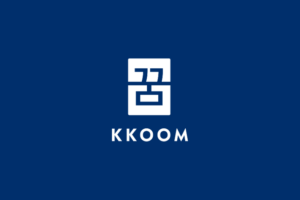 KKOOM's white stamp logo centered on a dark blue background.